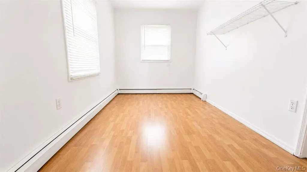 Bedroom with hardwood floor and natural light