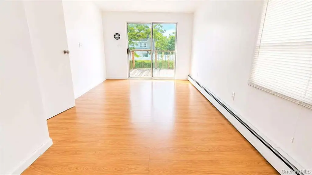 Living and dining area opening to the backyard deck