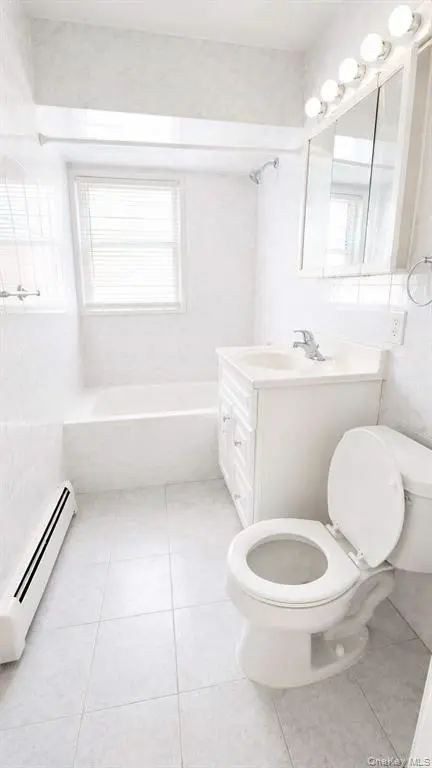 Full bathroom with tub and window
