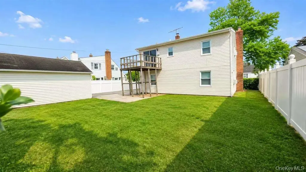 Rear exterior with deck and fenced backyard