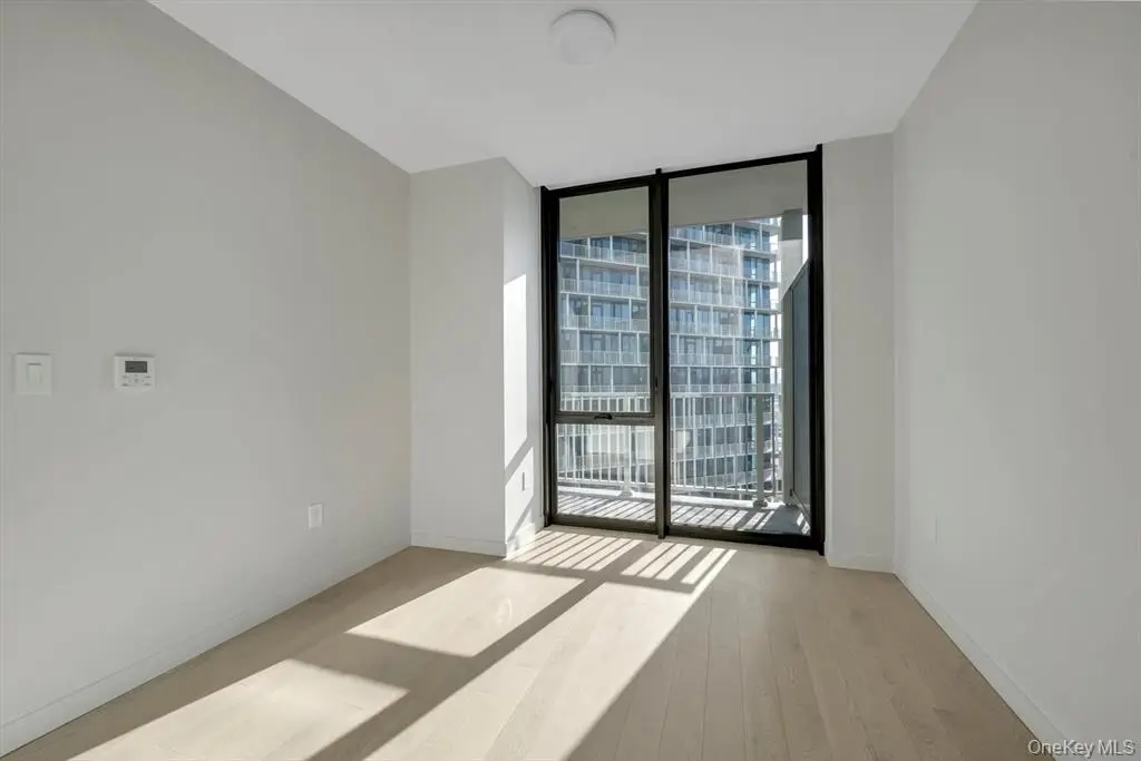 Bedroom with large window and built-in storage