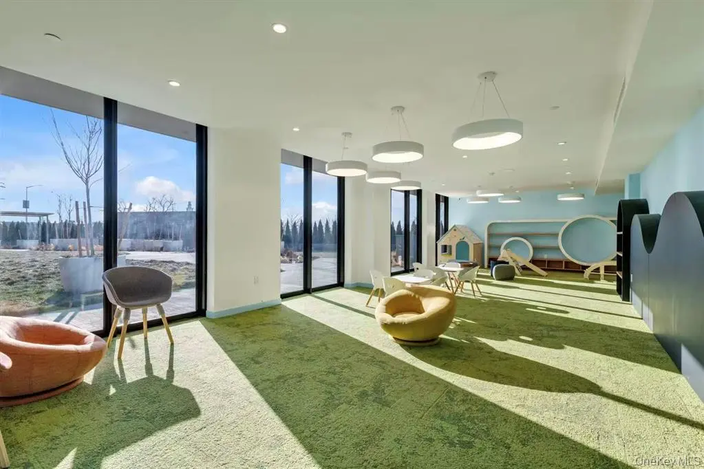 Bright resident lounge with floor-to-ceiling windows