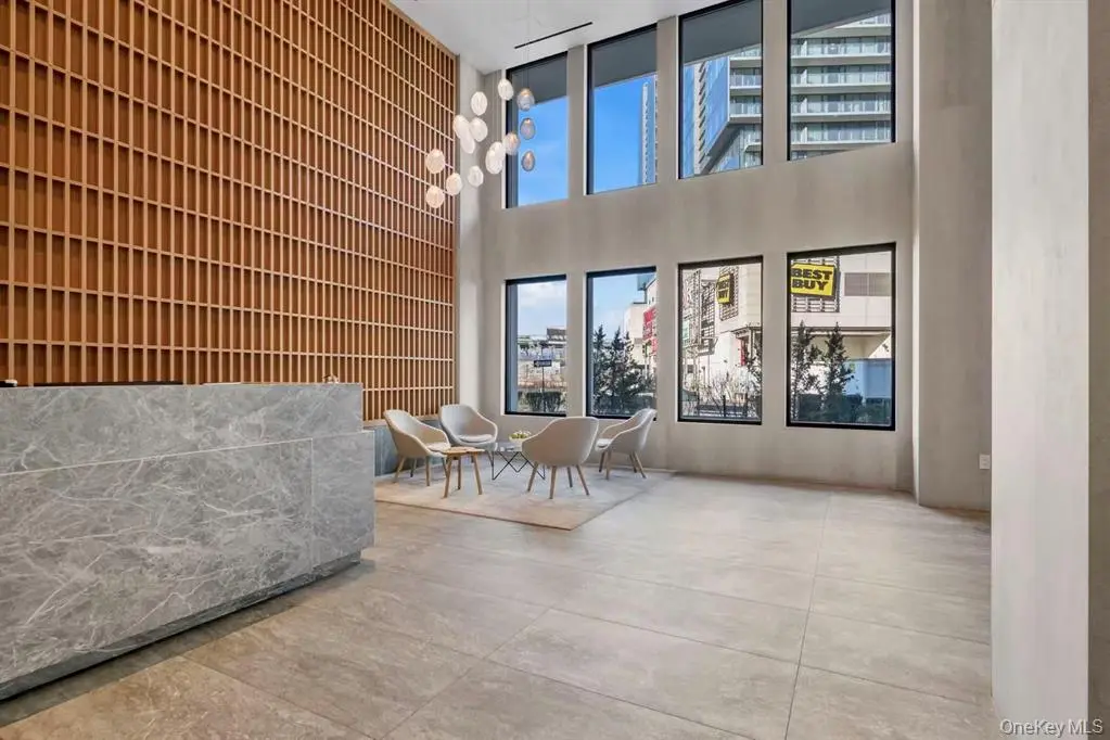 Double-height condominium lobby with lounge seating