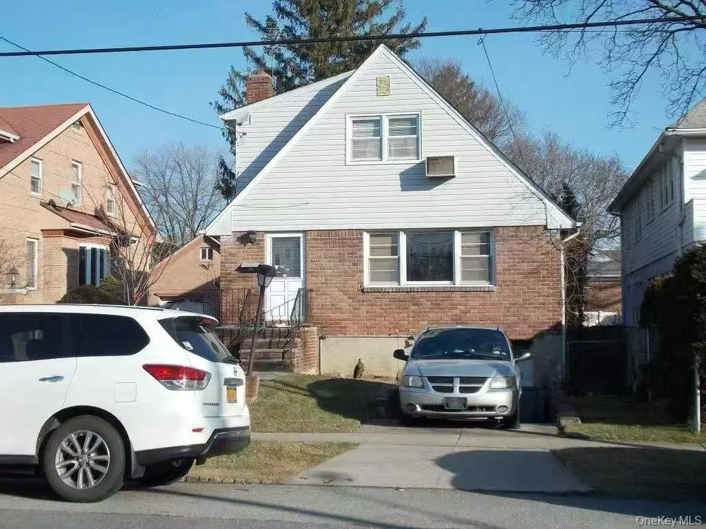 Whitestone detached single-family renovation opportunity — front exterior with driveway and attached garage