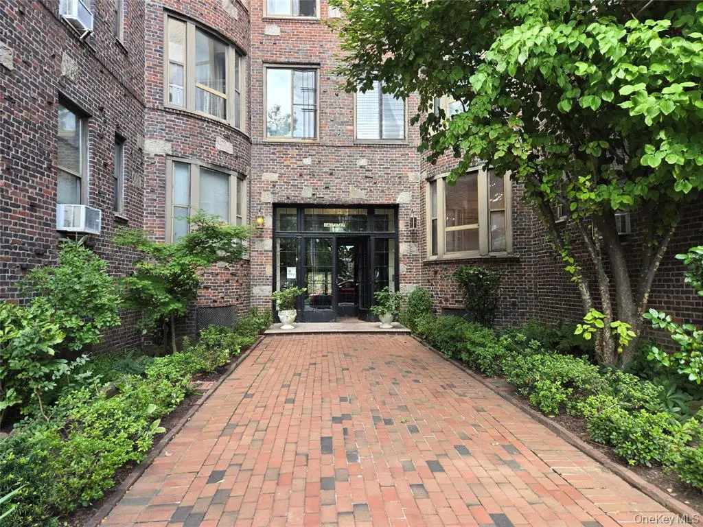 Flushing two-bedroom cooperative apartment — brick courtyard entrance